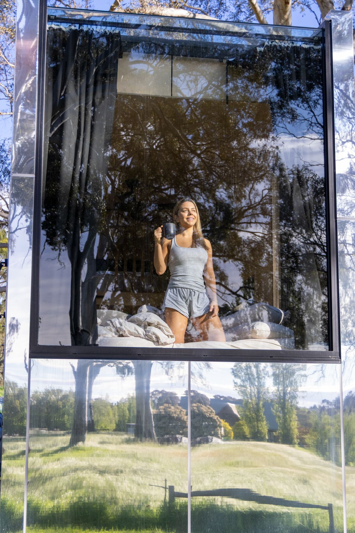 A guest seen through the glass wall of a cabin